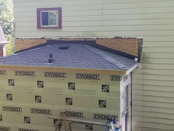 The rear addition with its new shingle roof on, still in house wrap